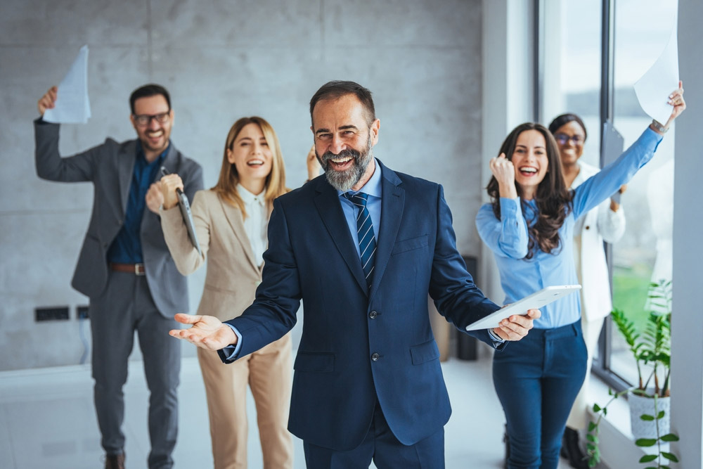 Five office professionals celebrating and excited